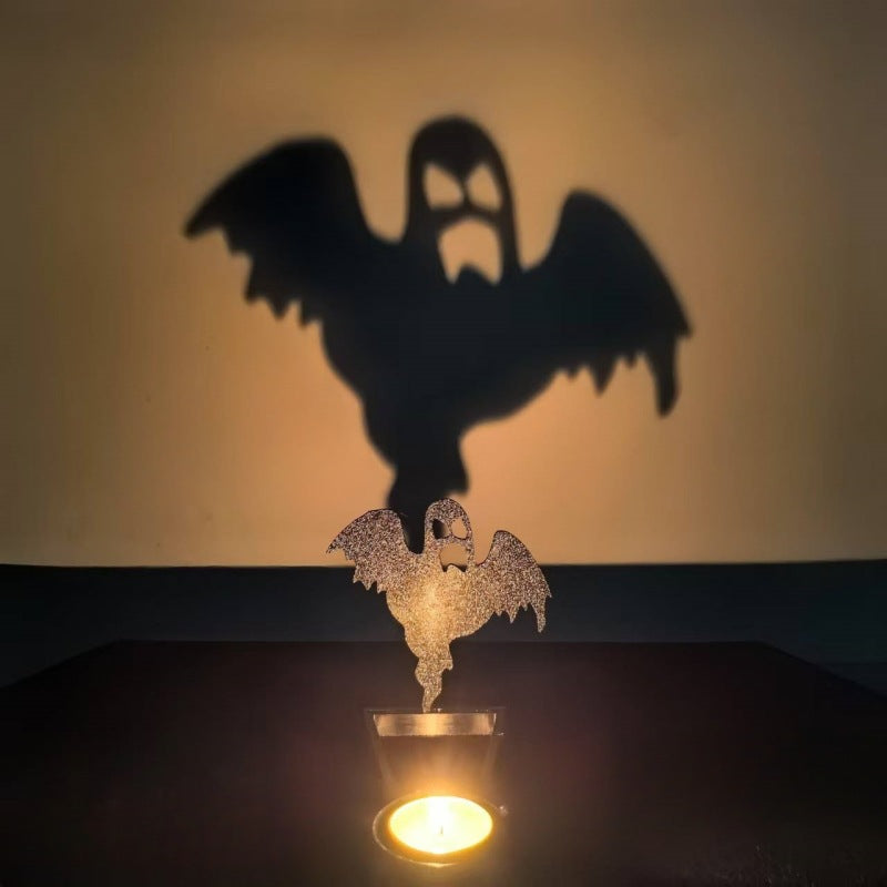 Fairy ghost Halloween shadow candle holder casting a winged ghost silhouette on the wall