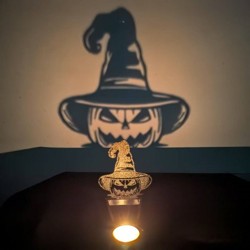Pumpkin witch hat Halloween shadow candle holder casting a grinning jack-o-lantern shadow on the wall
