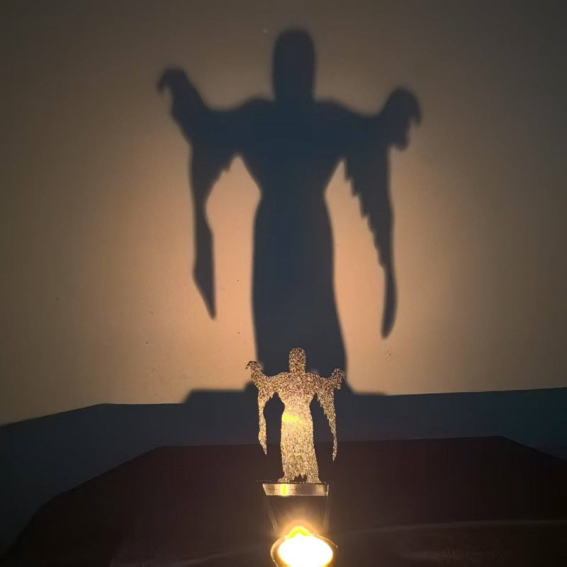Big ghost Halloween shadow candle holder projecting a tall hooded reaper silhouette on the wall