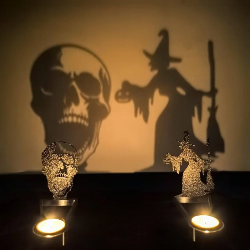 Halloween shadow candle holders casting giant skull and broom witch silhouettes on a wall from tealight candles